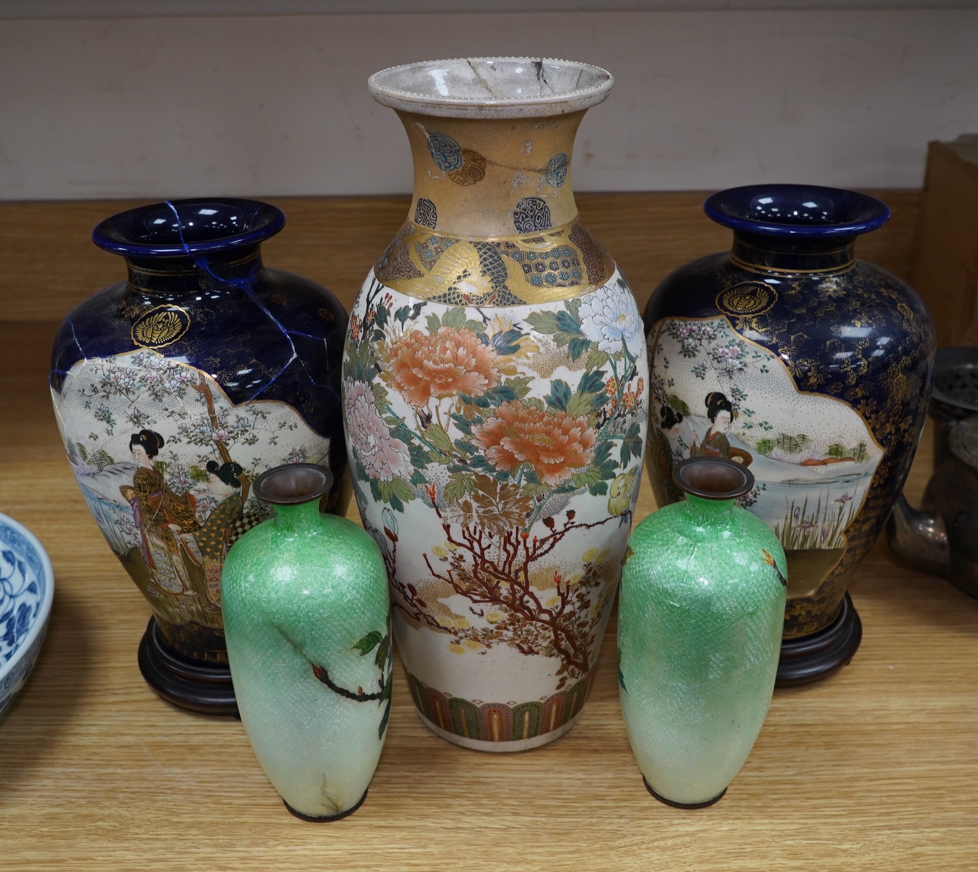 A pair of Japanese Satsuma vases on stands, a pair of floral enamel vases and another Satsuma pottery vase, largest 35cm high. Condition - poor